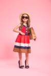 little-fashionista-with-shopping-bag-summer-hat-glasses-colored-pink-background-mom-s-shoes-concept-children-s-fashion_169016-4513